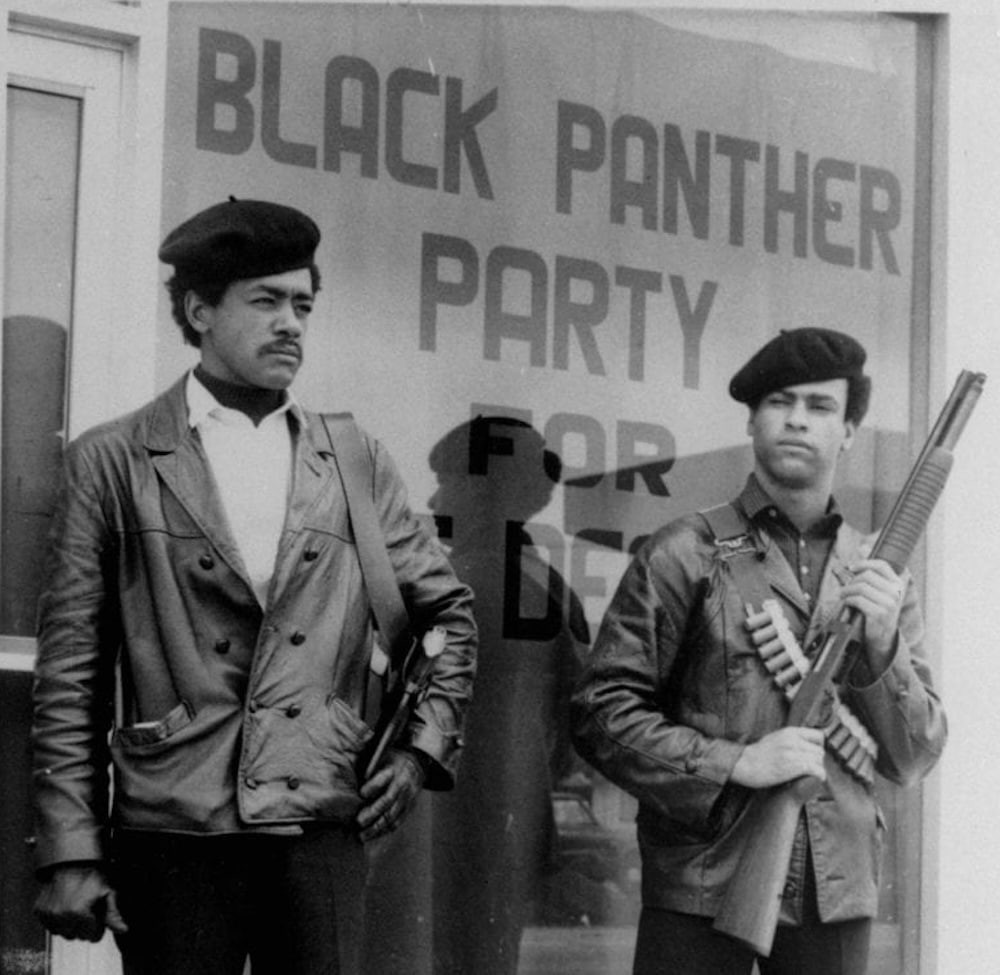 Bobby Seale Huey P. Newton Black Panther Party Photo holding gun and rifle dressed in berets and leather jackets.